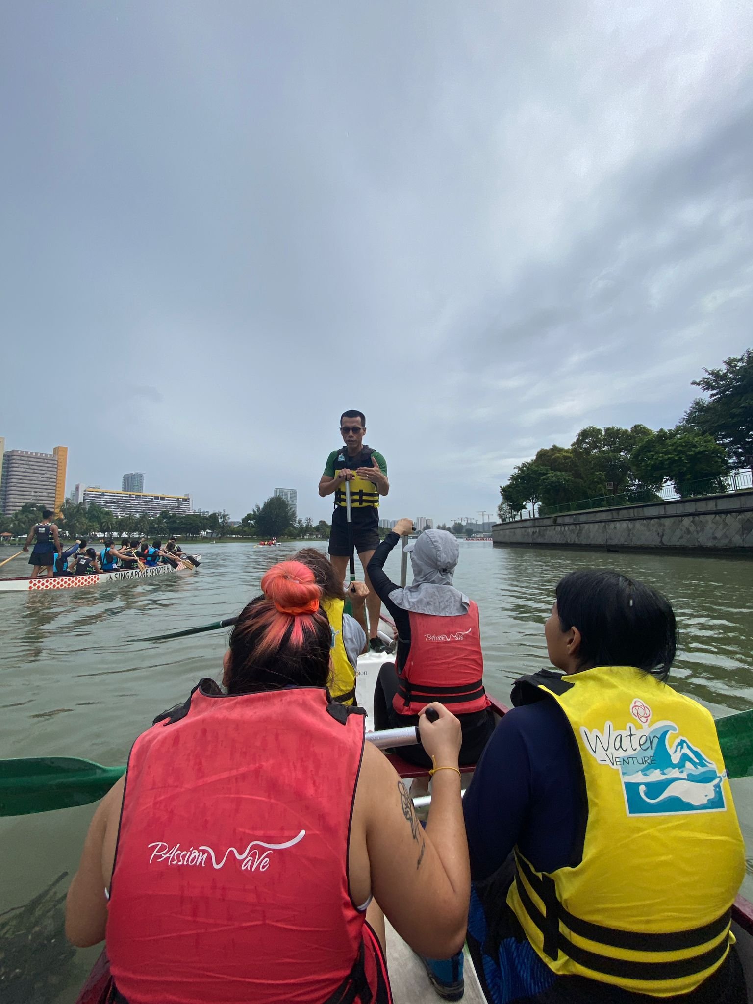 Participants working together during the Upliven Community dragon boating activity